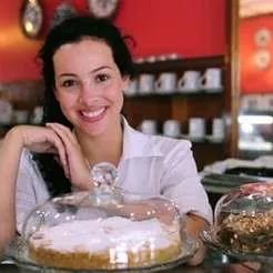 Cafe owner standing behind counter – small business career path