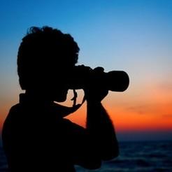 Photographer taking pictures outdoors with camera