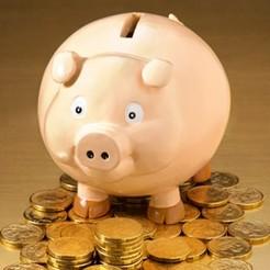 Pink piggy bank with coin slot, symbolizing saving money or financial planning